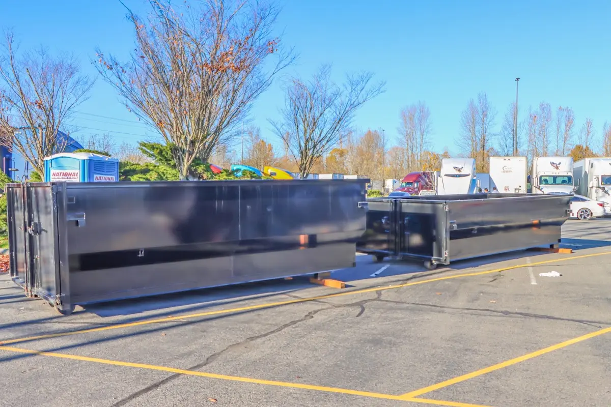 Professional dumpster rental service with roll-off container on residential driveway in Moultrie
